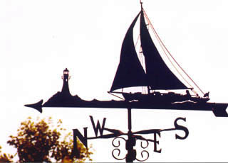 Yacht with Lighthouse weathervane